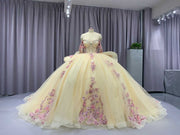 Champagne off shoulder sweetheart gown with appliqué detailing.