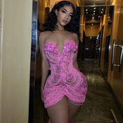 Woman Wearing a Pink Tassel Beading Birthday Dress with Fringe Accents and Sparkling Embellishments, Styled for Luxe Celebrations