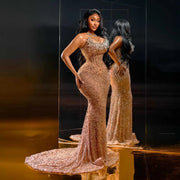 Golden beaded prom dress with luxury detailing and fitted silhouette.