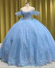 Sky blue quinceañera ball gown with glitter tulle, beaded sleeves, and full princess skirt.