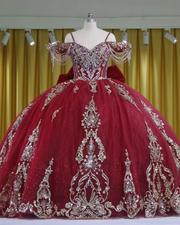 Burgundy Quinceañera dress with crystal tassels, spaghetti straps and corset bodice