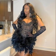 Mannequin Wearing a Black Sheer Neck Feathers Birthday Dress with Dramatic Feather Accents and Elegant Detailing, Styled for Luxe Celebrations