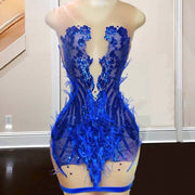 Mannequin Wearing a Royal Blue Feathered Birthday Dress with Dramatic Trim, Styled for Glamorous Celebrations