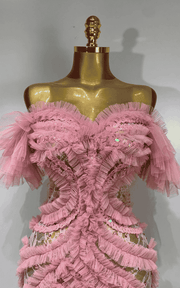 Elegant pink mesh evening gown with soft flowing fabric and feminine silhouette