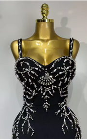 Sasha black bandage maxi dress with a deep V-neckline and hand-sewn black beadwork in a bodycon long silhouette.