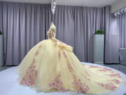 Champagne off shoulder sweetheart gown with appliqué detailing.