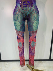 Stand out in the Raiz colorful rhinestone mesh bodycon jumpsuit. Sexy V-neck outfit for stage performances, parties, birthdays, and events.