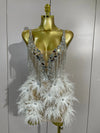 Angeli sheer mesh mini dress featuring sparkling rhinestones, decorative chains, mirror-like accents, and feather details