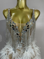 Angeli sheer mesh mini dress featuring sparkling rhinestones, decorative chains, mirror-like accents, and feather details