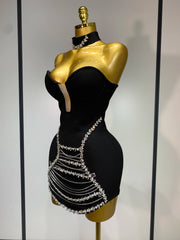 Jamilah strapless mini bodycon dress with rhinestone chain detailing and backless design for women’s birthday or evening parties.