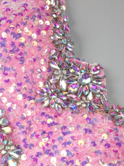 Pink floor-length sequin gown with crystal beading, feathers, and thigh-high slit – perfect for homecoming, prom, and evening parties.