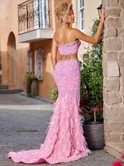 Pink floor-length sequin gown with crystal beading, feathers, and thigh-high slit – perfect for homecoming, prom, and evening parties.