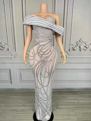 Elegant long-sleeve evening dress with a detailed pattern of sparkling pearls and rhinestone embellishments. Skai luxury formal gown.