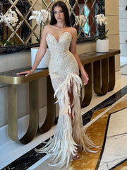 Selah nude strapless crystal embellished gown with feathers and high side slit – elegant sheath dress for homecoming, prom, and glamorous evening events.