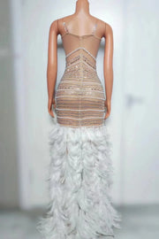 Tiana sparkly long prom dress with rhinestones, pearls, and feather details.