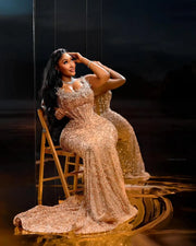 Golden beaded prom dress with luxury detailing and fitted silhouette.