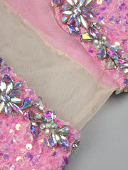 Pink floor-length sequin gown with crystal beading, feathers, and thigh-high slit – perfect for homecoming, prom, and evening parties.