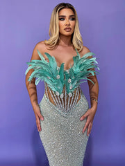 Zahara strapless blue mermaid prom dress with sweetheart neckline, sequins, feathers, and beaded diamonds.