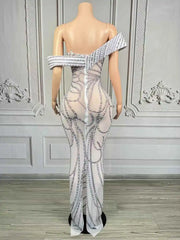 Elegant long-sleeve evening dress with a detailed pattern of sparkling pearls and rhinestone embellishments. Skai luxury formal gown.