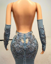 Glitter light blue prom dress with rhinestone mesh and see-through design, styled for formal events and glamorous occasions.