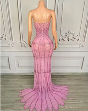 Nylah strapless rhinestone prom dress with high slit and see-through mesh design.