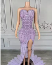 Nylah strapless rhinestone prom dress with high slit and see-through mesh design.
