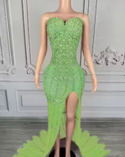 Nylah strapless rhinestone prom dress with high slit and see-through mesh design.
