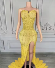 Nylah strapless rhinestone prom dress with high slit and see-through mesh design.