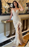 Selah nude strapless crystal embellished gown with feathers and high side slit – elegant sheath dress for homecoming, prom, and glamorous evening events.