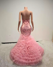 Beaded pink prom dress with rhinestone bodice and layered ruffle skirt, styled for formal events and glamorous occasions.