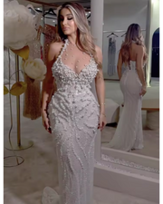 white mesh halter dress with pearl embellishments, styled for elegant evenings and bridal-inspired events.

