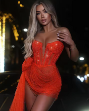 Siena coral short evening dress with sweetheart neckline and sparkly sequins, styled for semi-formal events and glamorous nights.