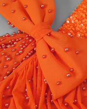 Siena coral short evening dress with sweetheart neckline and sparkly sequins, styled for semi-formal events and glamorous nights.