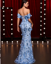 Maris off-the-shoulder gown with 3D floral appliqué and fishbone corset, styled for weddings and high-formality events.