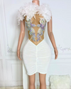 Sleeveless white birthday dress with feather accents and rhinestones, styled for glamorous parties and elegant evening events.