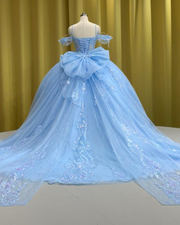 Sky blue quinceañera ball gown with glitter tulle, beaded sleeves, and full princess skirt.