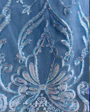 Light blue quinceañera gown with flowing princess-style skirt and fitted bodice.