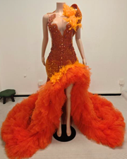 Orange sequin mermaid prom dress with deep V neckline and ruffled tulle train