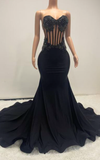 Eden black mermaid evening gown with sheer beaded corset bodice and flowing train for evening events, birthdays, or stage appearances.