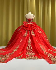 Royal red tulle ball gown with gold embellished bodice and large back bow