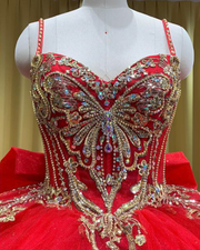 Royal red tulle ball gown with gold embellished bodice and large back bow