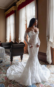 Lace sweetheart mermaid wedding dress with lace appliqués and sweep train for brides.