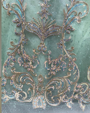 Mint green glitter quinceañera ball gown with rose gold appliqué and crystal corset bodice.