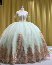 Mint and rose gold quinceañera gown with tulle skirt, rose gold appliqués, and fitted bodice.