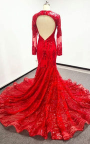 Luxury formal gown featuring illusion sleeves and dramatic train