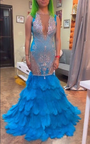 High-end party dress featuring crystal bodice and layered feather skirt