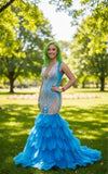 High-end party dress featuring crystal bodice and layered feather skirt