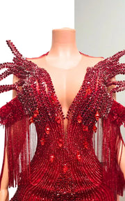 Ruby red beaded mermaid gown with sculptural chest fin details, sequin fringe off-the-shoulder sleeves, and floor-length illusion train