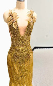 Radiant gold sequin mermaid gown with 3D gilded leaf appliqués, illusion plunging neckline, and circular cathedral train