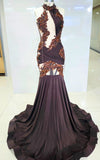 Deep brown mermaid gown with bronze baroque appliqués, asymmetrical cut-outs, and draped halter neckline